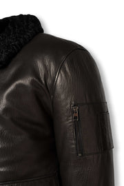 Black shearling leather bomber jacket with curly lamb collar and military-inspired design