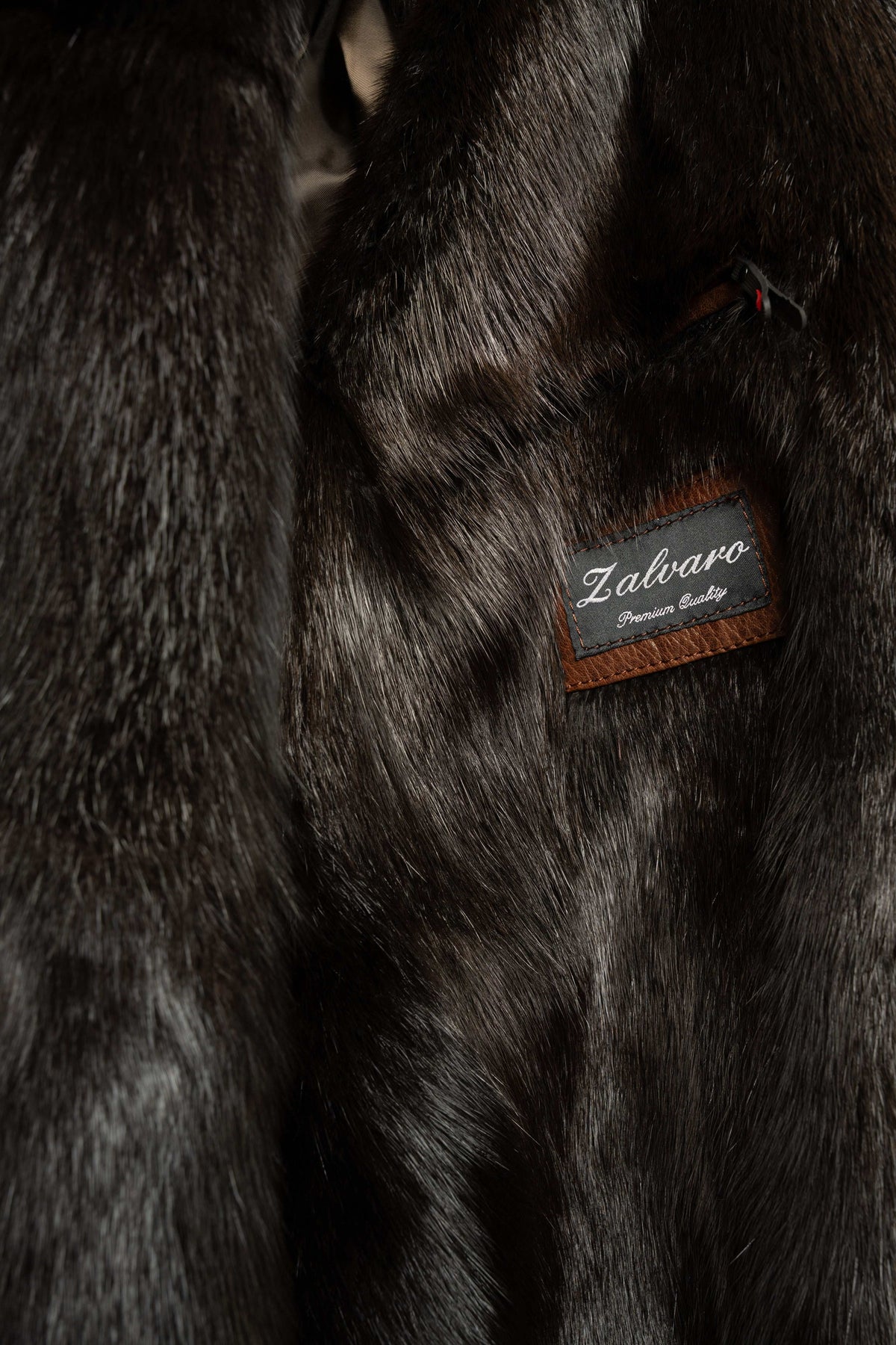 Men's brown leather bomber jacket with black mink fur collar on a mannequin