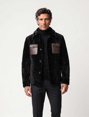 Black premium shearling jacket with leather pockets and modern tailoring