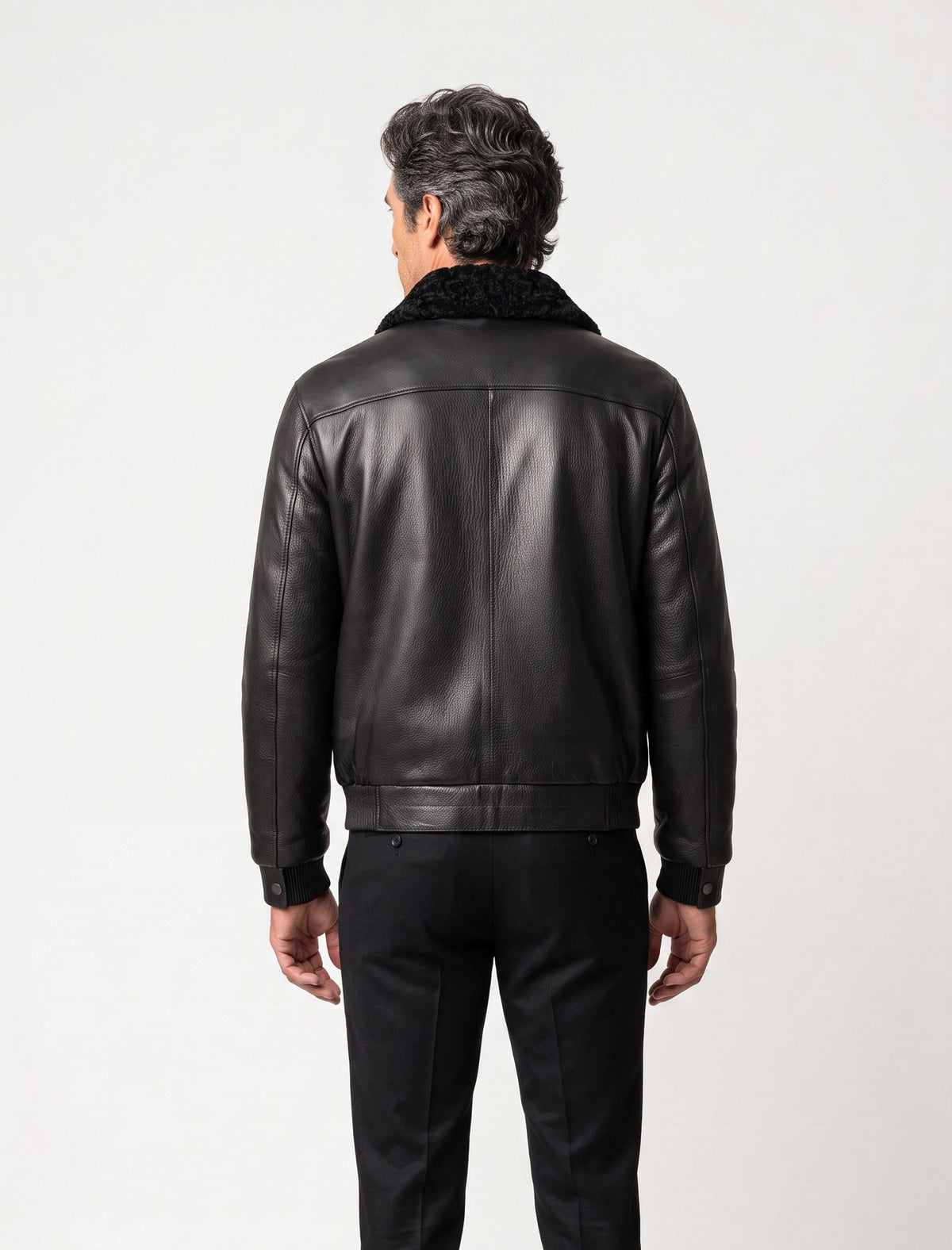 Black shearling leather bomber jacket with curly lamb collar and military-inspired design