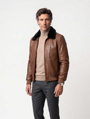 Men's brown leather bomber jacket with black mink fur collar on a model