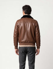 Men's brown leather bomber jacket with black mink fur collar on a male model