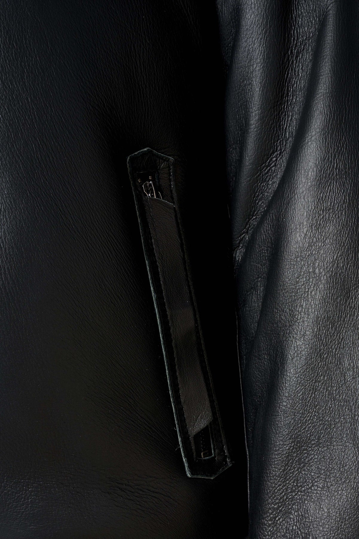Arctic black hooded shearling leather jacket with minimalist design and plush lining