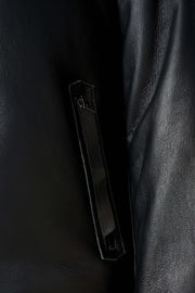 Arctic black hooded shearling leather jacket with minimalist design and plush lining